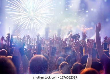 New Year Concept - Fireworks And Cheering Crowd Celebrating The New Year