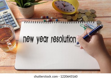 NEW YEAR CONCEPTUAL TEXT. Hand writing on notepad on a wooden table. - Shutterstock ID 1220643160