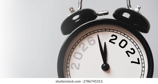 New year countdown and time management concept with black alarm clock transition change from 2026 to 2027 Symbol of deadline, business planning, urgency, target achievement and future goals.