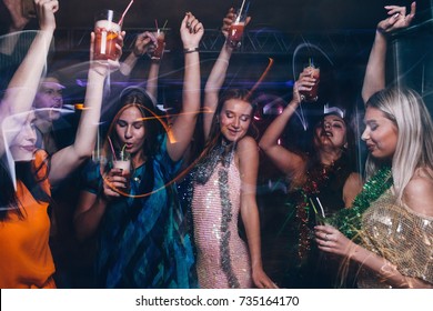 New Year Dance Party In Night Club. Happy Friends Company With Drinks, Christmas Celebration In Motion. Disco People In Blurred Colors, Modern Youth Life