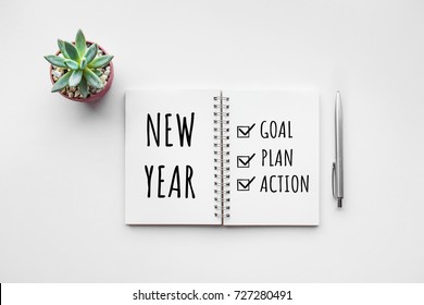 New year goal,plan,action text on notepad with office accessories.Business motivation,inspiration concepts