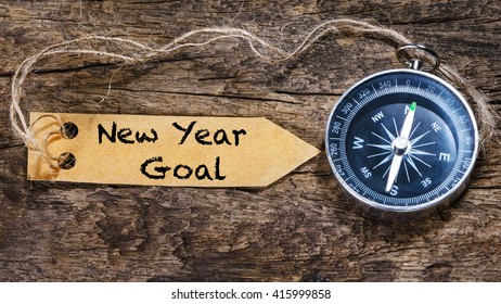 New year goals - motivation handwriting on label with compass