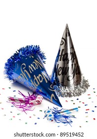 New year hats and party horn blowers with colorful confetti for holiday decoration.