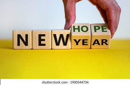 New year and hope symbol. Businessman turns cubes and changes the words 'new year' to 'new hope'. Beautiful white and yellow background. Copy space. Business and new year -  hope concept. - Shutterstock ID 1900544734