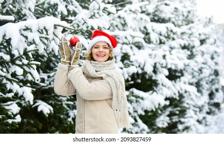 New Year New Me. Happy New Year. Xmas Holiday. Time To Celebrate. Woman Red Santa Hat Hold Decorative Ball. Winter Shopping Sale. Decorate Your Tree And Home. Merry Christmas To Everyone