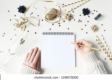 New Year Resolution, Wish List Concept. Blank Letter Mock-up. Gold Party Decoration, Confetti And Wine Glass On White Table Background. Flat Lay, Top View.