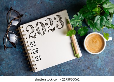 New year resolutions 2023 on desk. 2023 resolutions list with notebook, coffee cup on table. Goals, resolutions, plan, action, checklist concept. New Year 2023 template, copy space - Shutterstock ID 2195980061
