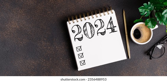 New year resolutions 2024 on desk. 2024 goals list with notebook, coffee cup, plant on table. Resolutions, plan, goals, action, checklist, idea concept. New Year 2024 resolutions, copy space
