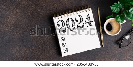New year resolutions 2024 on desk. 2024 goals list with notebook, coffee cup, plant on table. Resolutions, plan, goals, action, checklist, idea concept. New Year 2024 resolutions, copy space
