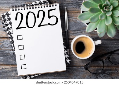 New year resolutions 2025 on desk. 2025 goals list with notebook, coffee cup, plant on wooden table. Resolutions, plan, goals, action, checklist, idea concept. New Year 2025 resolutions. Copy space