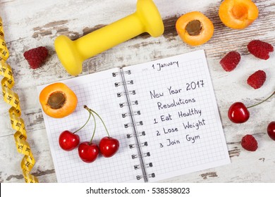 New Year Resolutions Or Goals Eat Healthy, Lose Weight And Join Gym Written In Notebook, Fresh Fruits, Dumbbells For Fitness And Tape Measure