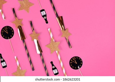 New Year Silvester Celebration Flat Lay With Golden, Black And White Striped Paper Stars And Champaign Flute And Clock Paper Decoration On Pink Background