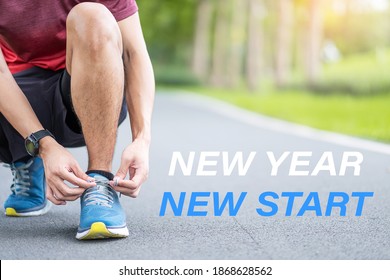 New Year New Start With Young Man Tying Shoelace In The Park Outdoor, Athlete Runner Man Ready For Running And Jogging In Morning. Fitness, Wellness, Healthy Lifestyle And New You Concepts