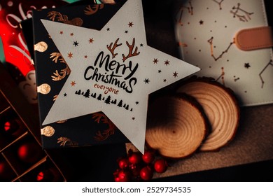 New Year toy with Christmas decorations, notepad, round wooden coasters, gifts and pine cone on a black wooden background. - Powered by Shutterstock