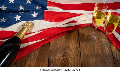 New Year New Year's Eve Sylvester or other holiday celebration background USA - American flag, sparkling wine or champagne bottle and glasses on wooden table, top view - Powered by Shutterstock