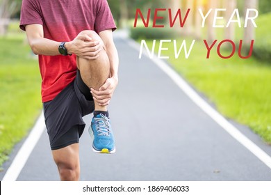 New Year New You With Young Man Stretching Muscle In The Park Outdoor, Runner Warm Up Ready For Running And Jogging In Morning. Fitness, Wellness, Healthy Lifestyle And New Start Concepts