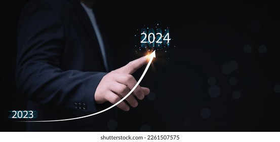 New years 2024 start up investment new business and finance. Businessman hand pointing graph on target 2024. Stock market, Business growth, progress or success - Shutterstock ID 2261507575