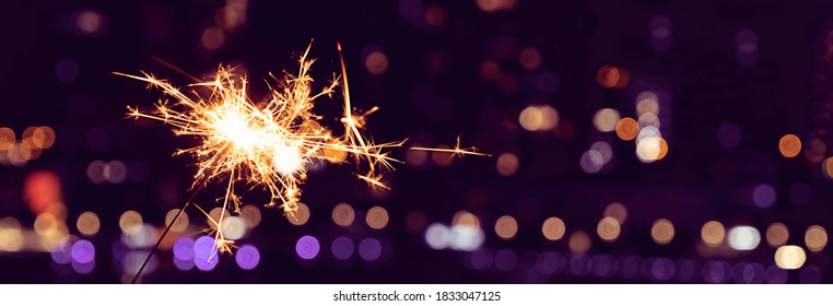 New Year's celebration sparkler in the night city - Powered by Shutterstock