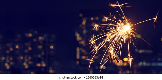 New Year's celebration sparkler at night - Shutterstock ID 1860383614