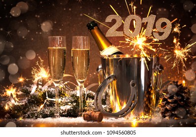 New Years Eve Celebration Background With Pair Of Flutes And Bottle Of Champagne In  Bucket  And A Horseshoe As Lucky Charm