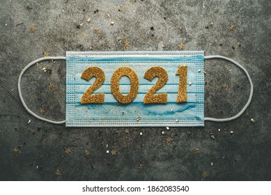 New Years Eve Celebration Concept Background.Medical Mask With The Numbers 2021.Covid-19 New Year Concept On Gray Background