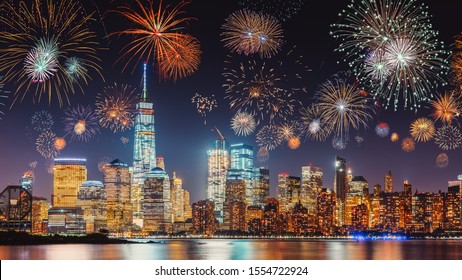 New Years Eve With Colorful Fireworks Over New York City Skyline Long Exposure With Dark Blue-purple Sky, Orange City Light Glow And Reflections In The River