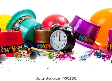 New Year's Hats, Noise Makers, Streamers, Balloons, Confetti And A Black Clock On A White Background