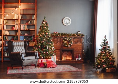 New Year's Interior General View. Christmas Tree Near Fireplace and Bookshelf. Interior Photo Studio with Christmas Decor