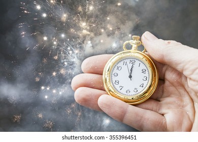 New Year's at midnight - Old clock with fireworks and holiday lights - Shutterstock ID 355396451