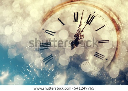 New Year's at midnight - Old clock with stars snowflakes and holiday lights