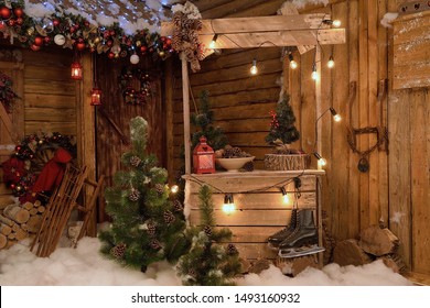 New Year's photo zone with snow near a wooden house.
Christmas decor: toys, Christmas trees, skis, garland, firewood, glowing light bulbs. festive mood. picture for postcard - Shutterstock ID 1493160932
