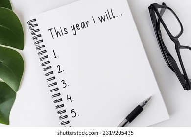 New Year's Resolutions Concept - Open notebook with text 