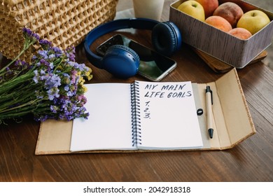 New Years Resolutions Life Goals list in open notebook on the table. Outdoor still life with My Life Goals motivational text. Self-development and motivation