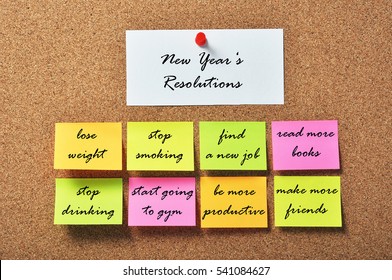 New Year's Resolutions On Notice Papers Hanging On A Cork Bulletin Board