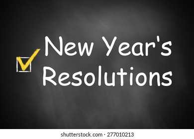 New Year's resolutions written on black chalkboard checkbox checked