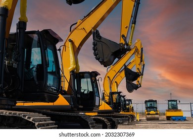 New Yellow Excavators are lined up in an open area. High quality photo