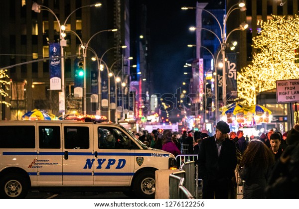 New York, New York - 12/24/2018 :\
NYPD police van blocking a road in Manhattan as the streets are\
filled with people waiting for a Christmas light show.\
