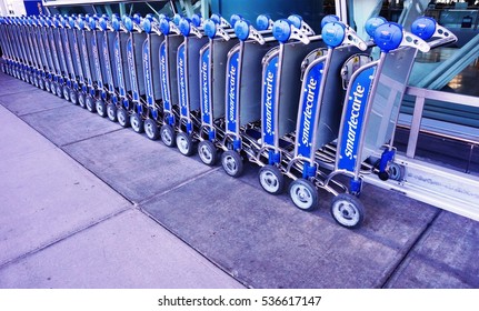 NEW YORK -27 NOV 2016- File Of SmarteCarte Paying Luggage Carts Awaits Passengers On The Curb  At The John F. Kennedy International Airport (JFK).