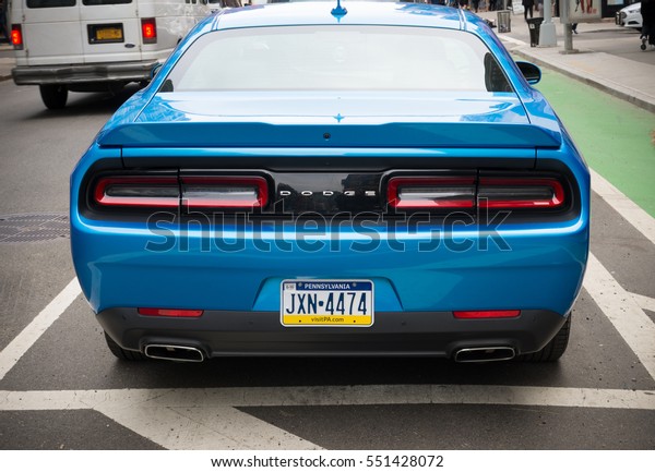NEW\
YORK - APRIL 29, 2016: Blue Dodge challenger in the streets of New\
York. It is the name of four different generations of American\
automobiles produced by Dodge in Detroit,\
Michigan