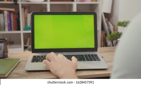 NEW YORK - April 5, 2019: Close Up Laptop Computer With Green Screen Chroma Key Display Internet Business Office Technology Work Desk Connection Keyboard Pc Device Using Slow Motion