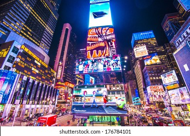 NEW YORK, NEW YORK - APRIL 9, 2013: Times Square lights at night in Midtown Manhattan. The site is regarded as the world's most visited tourist attraction with nearly 40 million visitors annually.