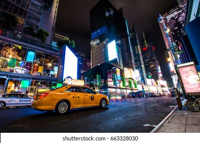 NEW YORK - AUG 10, 2015: Manhattan Street View At Night In New York City With A Yellow Taxi Close-up