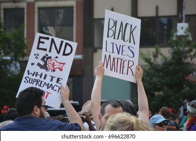 New York, New York. - August 13, 2017: People carrying signs at a rally in Union Square denouncing neo-nazi violence in Charlottesville, Virginia and President Trump in 2017 in New York City.