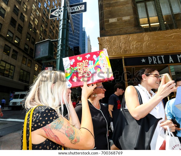 NEW YORK - AUGUST 21:  People Look Through Home\
Made Eclipse Viewers Made Out of Cereal Boxes As They Try and View\
Eclipse On And Near 42nd Street By Grand Central August 21, 2017 in\
New York City.