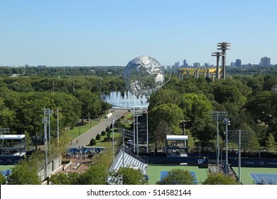 NEW YORK - AUGUST 23, 2016: Tennis courts at the Billie Jean King National Tennis Center and 1964 New York World's Fair Unisphere in Flushing Meadows Park 