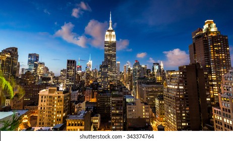 NEW YORK - AUGUST 23: View to Midtown Manhattan with the famous Empire State Building at sunset on August 23, 2015. This view is from the rooftop of the 230-fifth Bar.