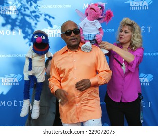 NEW YORK - AUGUST 25 Star Of ABC Shark Tank Daymond John With Sesame Street's Grover And Abby Cadabby At The Red Carpet Before US Open 2014 Opening Night Ceremony On August 25, 2014 In New York