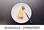 New York Cheese Cake serve on a white plate and fork