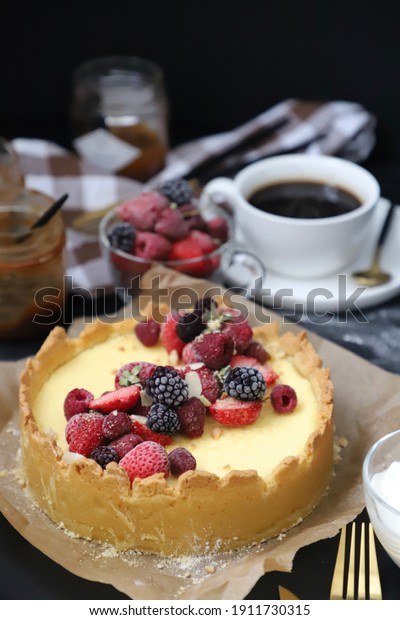 New York cheesecake\
with berries and caramel, appetizing holiday dessert, black\
background, close up