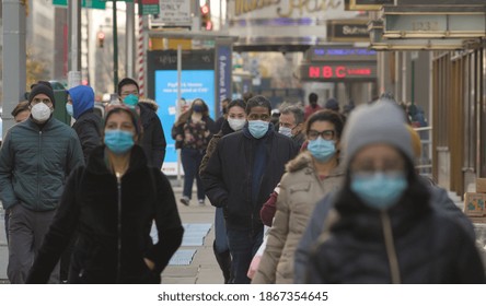 NEW YORK - CIRCA DECEMBER 2020: Crowd Of People Walking Street Wearing Masks During Covid 19 Pandemic 